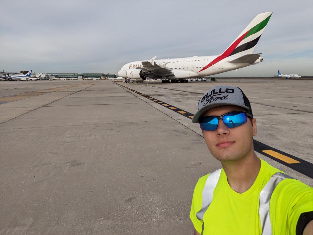 Bradley Shipes ramp agent selfie with Emirates A380 in background